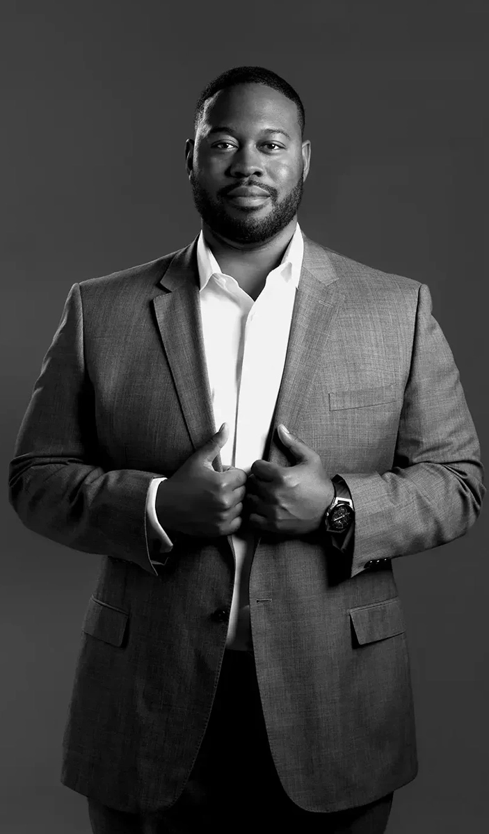 Attorney Robert Young IV stands in a suit